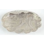 An Eastern white metal clam dish decorated with sea creatures, indistinctly marked to the reverse,