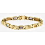 A 14ct yellow gold bracelet with textured panels of gold interspersed by coloured stones, length