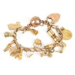 A 9ct yellow gold charm bracelet with a series of charms including miner's lamp, frog, spiders web