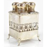 A George V hallmarked silver perfume bottle holder, with four clear glass perfume bottles, with