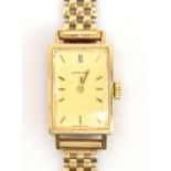 LONGINES; a lady's 9ct gold wristwatch, the rectangular dial set with batons, with 9ct gold strap,
