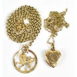 A 9ct yellow gold heart-shaped locket with foliate scroll decoration, suspended from a 9ct yellow