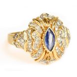 A 14ct yellow gold sapphire and diamond ring with elaborate setting and central lozenge shaped