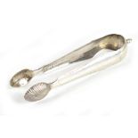 A pair of Continental white metal sugar tongs with acorn finial and chased detail, unmarked,