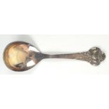 CHRISTIAN F HEIS; a Danish silver serving spoon, the cast floral handle with planished detail,
