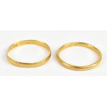 Two 22ct yellow gold bands, approx 4.4g (2).Additional InformationDents, misshaping, scratches and