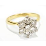 An 18ct yellow gold diamond daisy cluster ring, the central diamond approx 0.15cts, size J/K, approx