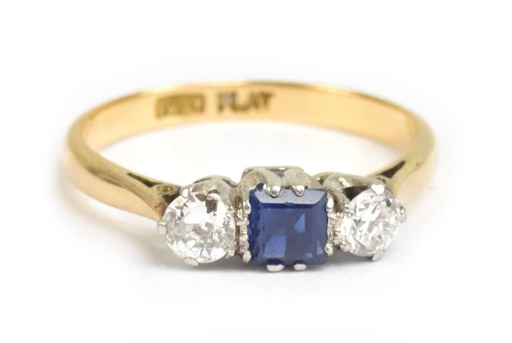 An 18ct yellow gold diamond and sapphire three stone ring, the central sapphire weighing approx 0.