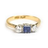 An 18ct yellow gold diamond and sapphire three stone ring, the central sapphire weighing approx 0.