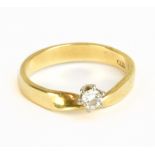 An 18ct yellow gold and diamond solitaire ring, the round brilliant cut stone approx 0.10cts in