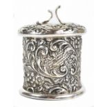 A late Victorian hallmarked silver string box, with all over embossed scroll decoration and lift-off
