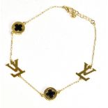 LOUIS VUITTON; an 18ct yellow gold bracelet set with two monogrammed plaques flanked by circular