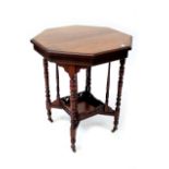 An Edwardian mahogany octagonal occasional table raised on turned columns united by galleried