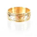 A 14k tri-colour band ring, middle band of three colour gold within rope twist border, marked 14k,