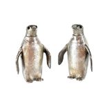 An Elizabeth II pair of hallmarked silver salt and pepper shakers in the form of penguins,