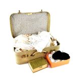 A vintage faux snakeskin suitcase containing a quantity of late Victorian and early 20th century