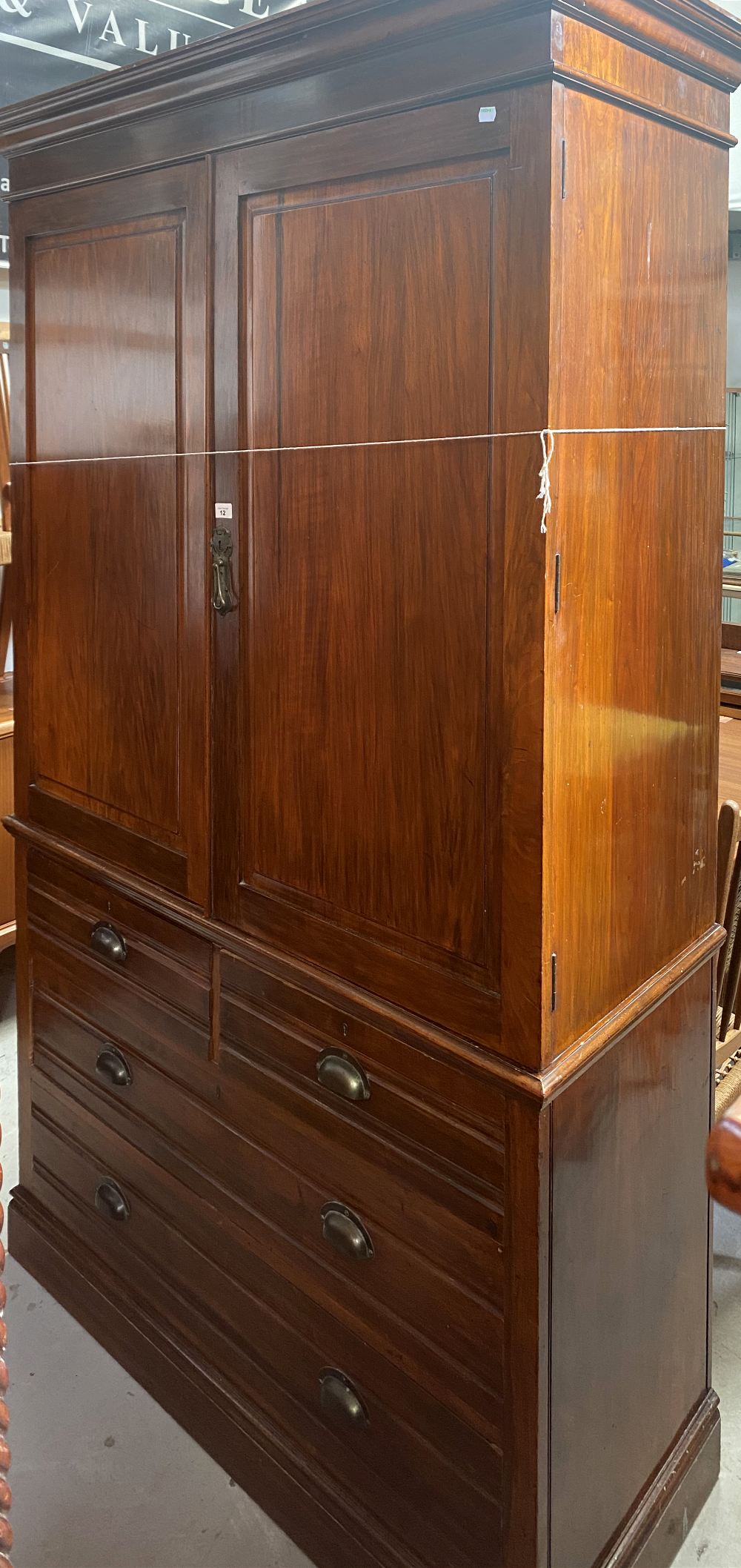 A 20th century walnut linen press with pair of panel doors enclosing four internal drawer slides