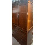 A 20th century walnut linen press with pair of panel doors enclosing four internal drawer slides