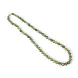 A green jade graduated bead necklace, length 51cm.