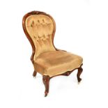 A Victorian walnut-framed spoon-back chair, front cabriole carved supports to castors.