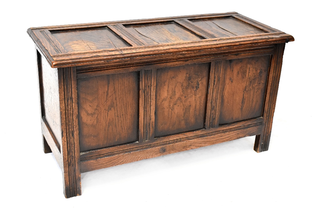 A late 18th/early 19th century oak blanket box, three panels to the top over three lower panels,