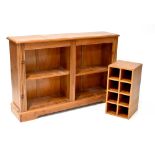 A contemporary pine two-tier bookshelf with reeded columns to either side, on plinth base,