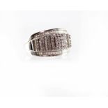 A 9ct white gold ring set with three diamond chips within baguette-cut diamond borders,