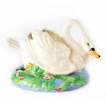 A Clarice Cliff bowl in the form of a swan on a hand painted stylised pond base,