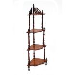 A Victorian walnut four-tier whatnot with urn and foliate inlay, height 146cm.