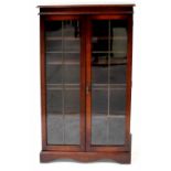 A 1930s display cabinet with glazed doors, raised on plinth feet, 120 x 117cm.