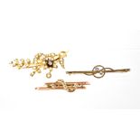 A yellow metal foliate and floral spray brooch set with single central diamond and small seed