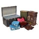 A vintage metal-bound travelling trunk, a leather suitcase,