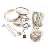 A collection of hallmarked silver jewellery to include a bangle, large locket on heavy chain,