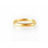 A 22ct yellow gold wedding band, size N1/2, approx 3.4g.