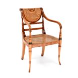A reproduction bergère caned mahogany-framed open arm elbow chair with painted floral decoration,