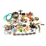 A quantity of vintage costume jewellery to include a silver bangle, enamelled brooches,