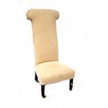 A Victorian prie dieu chair with later upholstery.