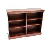 A reproduction mahogany low bookcase with central divide and four adjustable shelves, width 122cm,