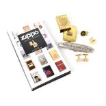 A collectors' lot comprising a white metal cigar case, a Zippo lighters book,