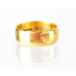 A 22ct wide band ring, size Q/R, width 7mm, approx 9.2g.