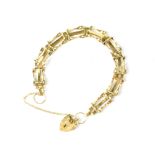 A 9ct gold gate bracelet with heart-shaped clasp and safety chain, approx 6.5g.