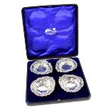 A cased set of four hallmarked silver bonbon dishes, repoussé and pierced decoration,