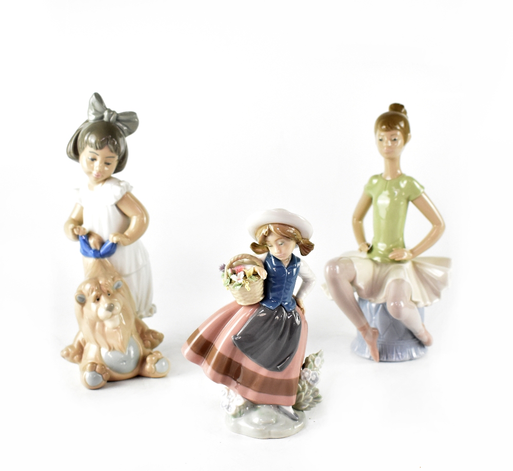 Three Lladró figures, a seated ballerina,