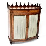 A 19th century walnut bow-fronted cabinet with galleried rim to the top over narrow frieze drawer,
