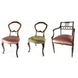 A pair of Victorian mahogany balloon-back dining chairs with non-matching seat covers,
