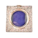 A Birmingham hallmarked silver circular picture frame with embossed decoration.