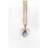 A 9ct gold pendant necklace set with cabochon sapphire and a single diamond in an Art Nouveau
