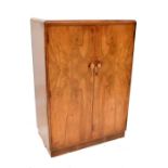 A 1940s walnut tallboy with internal hanging space and shelved section, width 84cm, height 120cm,