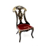 A Victorian papier mâché black lacquered, hand painted and mother of pearl inlaid chair (af).