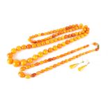 An amber necklace and a further amber necklace with matching earrings, combined approx 81g.